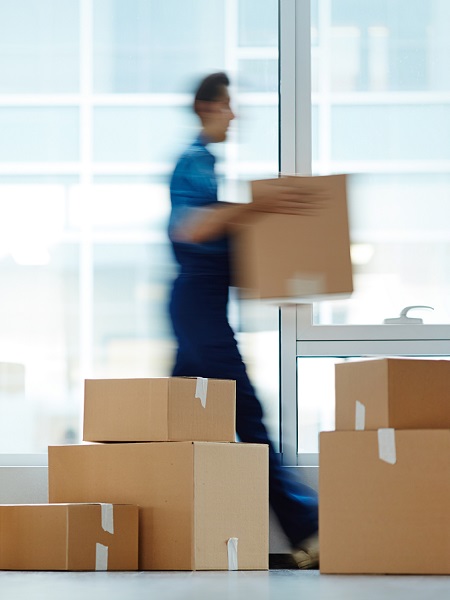 Blurred,Motion,Of,Contemporary,Worker,With,Packed,Box,Walking,To